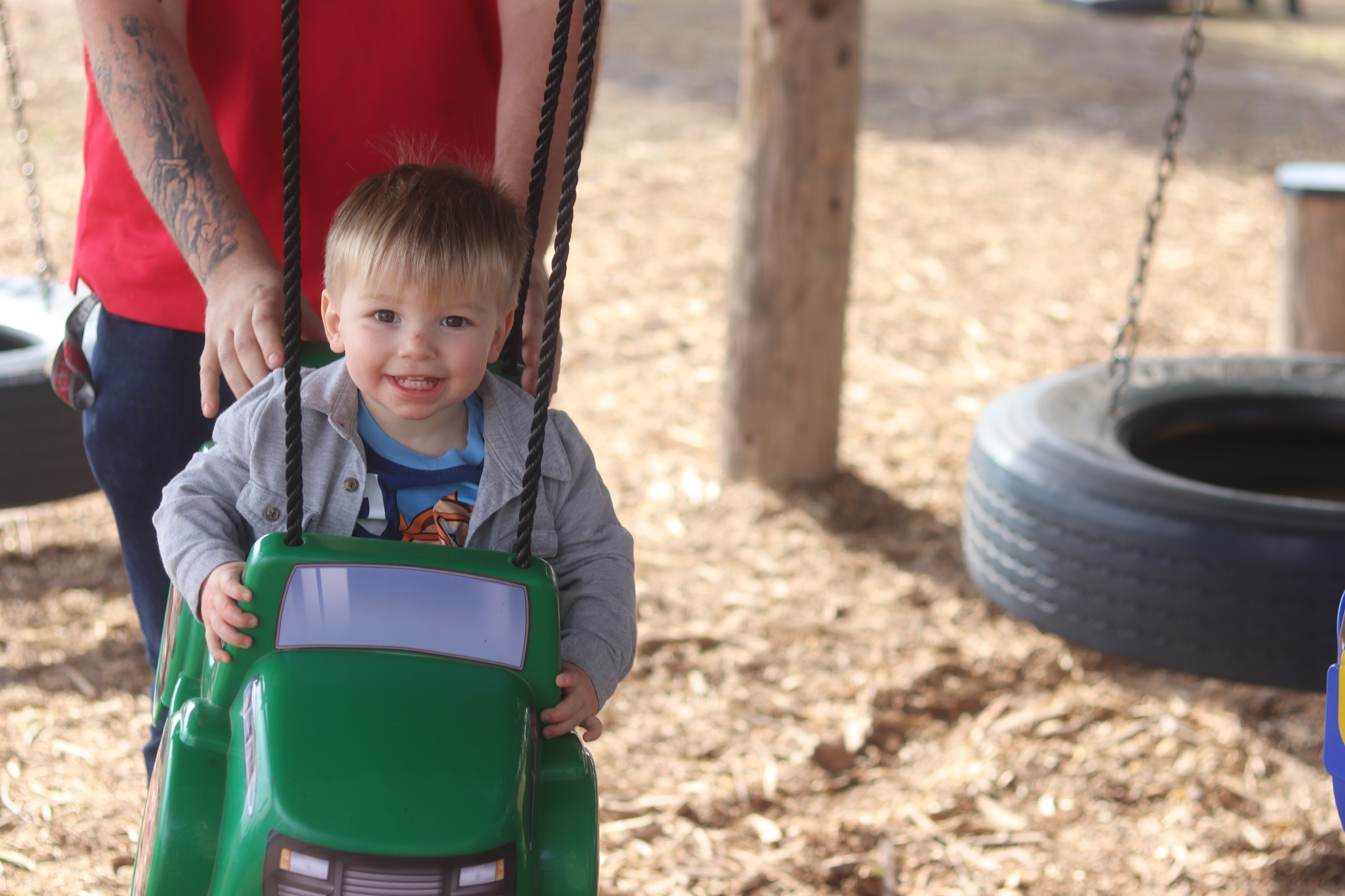 Picture of 2 year old boy on tire swing.